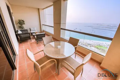 a dining room with a table and chairs and the ocean at High-floor 1BR Unit Close to Beach with Sea Views, Sadaf 6, Jumeirah Beach Residence by Deluxe Holiday Homes in Dubai