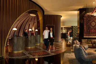 a man and woman standing in a hotel lobby at W Dubai - Mina Seyahi in Dubai