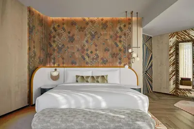 a bedroom with a large white bed with a floral wall at W Dubai - Mina Seyahi in Dubai