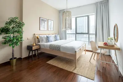 a bedroom with a bed and a large window at Frank Porter - The Point in Dubai
