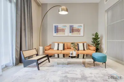 a living room with a couch and a table at Charming 2BR at Rawda Parkview Town Square Dubailand by Deluxe Holiday Homes in Dubai