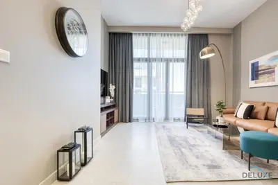 a living room with a couch and a table at Charming 2BR at Rawda Parkview Town Square Dubailand by Deluxe Holiday Homes in Dubai