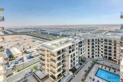 an aerial view of a building in a city at Charming 2BR at Rawda Parkview Town Square Dubailand by Deluxe Holiday Homes in Dubai