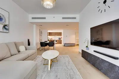 a living room with a couch and a table at Lovely sea view apt La Cote 1 La Mer 1min to beach in Dubai