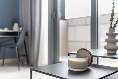 a table with a mirror and a cup on it at Silkhaus comfy DIFC studio with Burj Khalifa view in Dubai