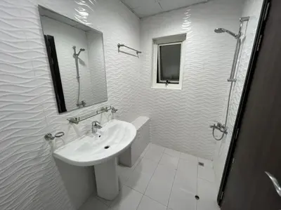 a white bathroom with a sink and a shower at Economical Rooms for rent in Dubai in Dubai