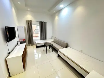 a hospital room with a couch and a table at Economical Rooms for rent in Dubai in Dubai