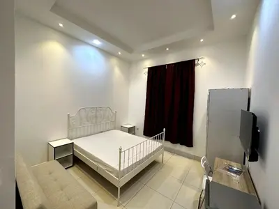 a bedroom with a crib and a red curtain at Economical Rooms for rent in Dubai in Dubai