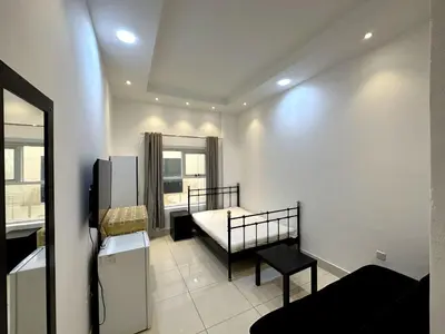 a small room with a bed and a window at Economical Rooms for rent in Dubai in Dubai