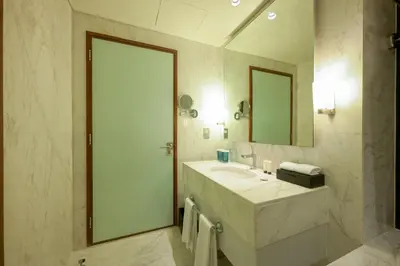 a bathroom with a sink and a mirror at Emaar Fashion Avenue - Formerly Address Dubai Mall Four Apple in Dubai