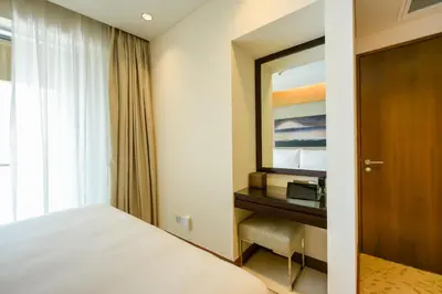 a hotel room with a bed and a mirror at Emaar Fashion Avenue - Formerly Address Dubai Mall Four Apple in Dubai