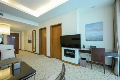 a living room with a couch and a flat screen tv at Emaar Fashion Avenue - Formerly Address Dubai Mall Four Apple in Dubai