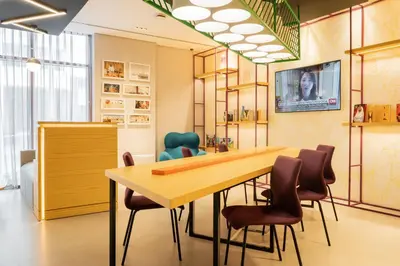 a conference room with a wooden table and chairs at Studio M Al Barsha Hotel by Millennium in Dubai