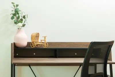 a desk with a vase and a chair on it at Dreamy and Spacious 3BR Unique Palm Jumeirah in Dubai