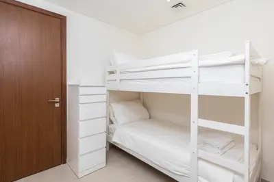 a white bunk bed in a room with a door at Spacious & Full of light 3BR+ kids Dubai Mall in Dubai
