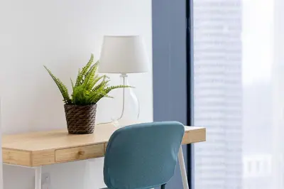 a desk with a blue chair and a plant on it at Spacious & Full of light 3BR+ kids Dubai Mall in Dubai