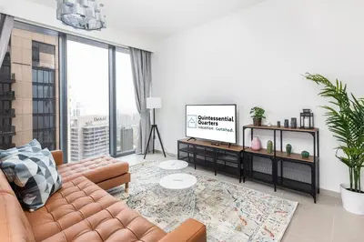 a living room with a couch and a large window at Spacious & Full of light 3BR+ kids Dubai Mall in Dubai