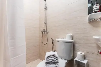 a bathroom with a shower and a toilet and a sink at Lovely & Pristine 2BR + kids - 7min to Dubai Mall in Dubai