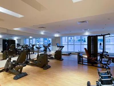 a gym with treadmills and exercise equipment in a building at Lovely & Pristine 2BR + kids - 7min to Dubai Mall in Dubai
