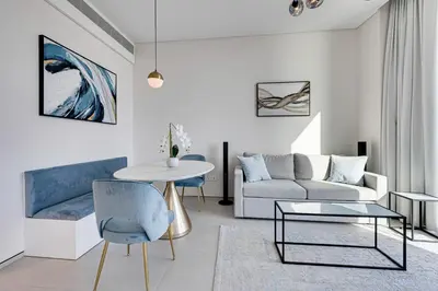 a living room with a couch and a table at Stylish 1BD apartment in Address Beach Residence in Dubai