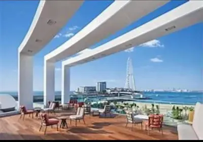 a large patio with a view of the ocean at 2 BDR Apt The Address Beach Resort JBR in Dubai