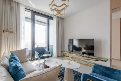 a living room with a couch and a tv at 2 BDR Apt The Address Beach Resort JBR in Dubai