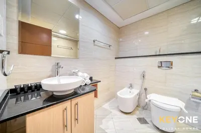 a bathroom with a sink and a toilet at Captivating Sky & Sea Views in Two Bedroom Suite in Dubai