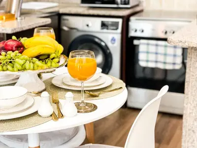 a table with a plate of fruit and orange juice at Luxury Studio Apartment Close to JBR Beach&Yacht Club&Metro-Available Airport Shuttle in Dubai