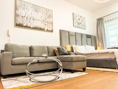 a living room with a couch and a bed at Luxury Studio Apartment Close to JBR Beach&Yacht Club&Metro-Available Airport Shuttle in Dubai