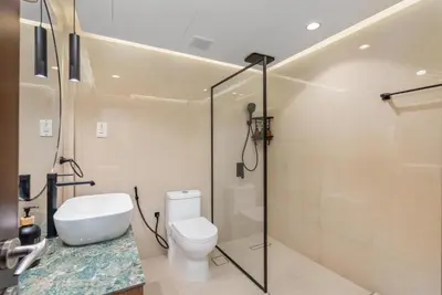 a bathroom with a toilet and a shower at Modern 1BR with City View Rooftop Pool Access in Dubai