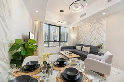 a living room with a couch and a table at Modern 1BR with City View Rooftop Pool Access in Dubai