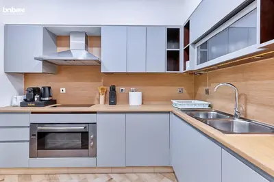 a kitchen with white cabinets and a sink at bnbme - Beachfront 1BR Palm Jumeirah Apt w Balcony Sea Views Pool & Beach Access in Dubai