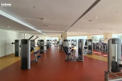 a gym with treadmills and cardio equipment in a building at bnbme - Beachfront 1BR Palm Jumeirah Apt w Balcony Sea Views Pool & Beach Access in Dubai