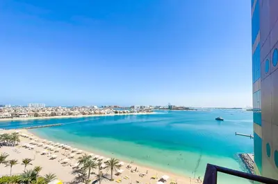a view of the beach from a building at bnbme - Beachfront 1BR Palm Jumeirah Apt w Balcony Sea Views Pool & Beach Access in Dubai