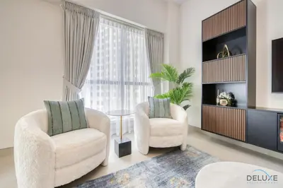 a living room with two chairs and a table at Spacious 3BR Apartment with Assistant Room in Sadaf 5 JBR by Deluxe Holiday Homes in Dubai