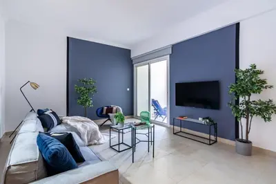 a living room with blue walls and a couch at The Smart Concierge - Plaza residence in Dubai