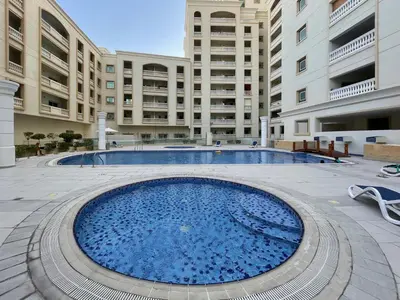 a large swimming pool in the middle of a building at The Smart Concierge - Plaza residence in Dubai