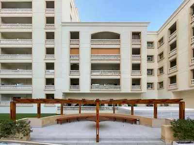 a building with a bench in front of it at The Smart Concierge - Plaza residence in Dubai