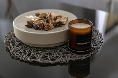 a candle and a plate of food on a table at HiGuests - Stylish Apartment in JBR Steps From the Beach in Dubai