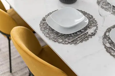 a dining room table with a white plate and silverware at HiGuests - Stylish Apartment in JBR Steps From the Beach in Dubai