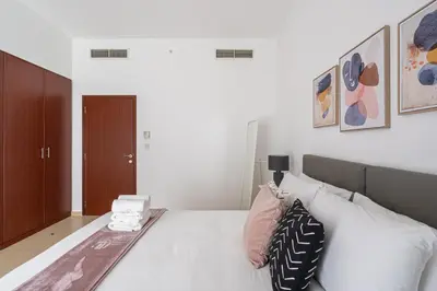a bedroom with a large white bed with pillows at HiGuests - Stylish Apartment in JBR Steps From the Beach in Dubai