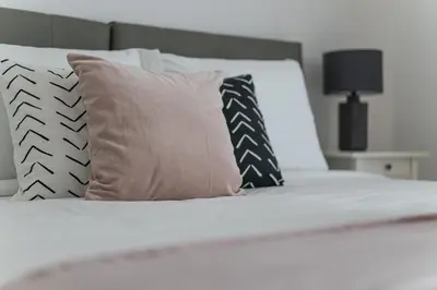 a bedroom with a white bed with pillows at HiGuests - Stylish Apartment in JBR Steps From the Beach in Dubai
