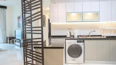a kitchen with a washing machine in a kitchen at AWS Holiday Homes - Luxury Living besides Canal in Dubai