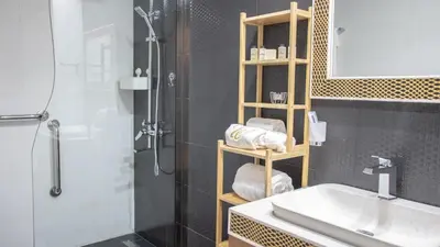 a bathroom with a shower and a sink and a shower at AWS Holiday Homes - Luxury Living besides Canal in Dubai