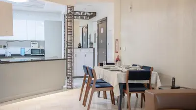 a kitchen and dining room with a table and chairs at AWS Holiday Homes - Luxury Living besides Canal in Dubai
