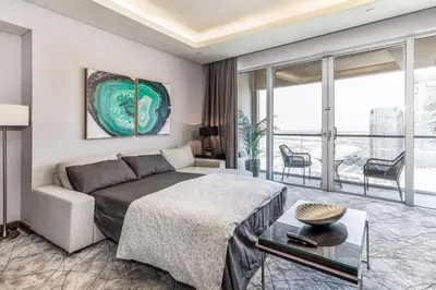a bedroom with a bed and a couch at Emaar Residences in Dubai
