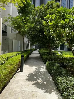 a sidewalk in a city with trees and a building at Burj Khalifa view, 3 Bedroom Apartment in Boulevard Point, Connected to Dubai Mall in Dubai