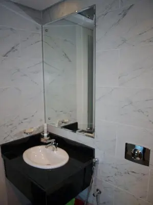 a bathroom with a sink and a mirror at Elegant and comfortably furnished 2BRH apartment in a quiet area! in Dubai