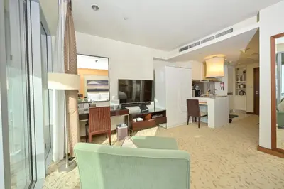a living room with a kitchen and a dining room at Emaar Fashion Avenue - Formerly Address Dubai Mall Residence in Dubai