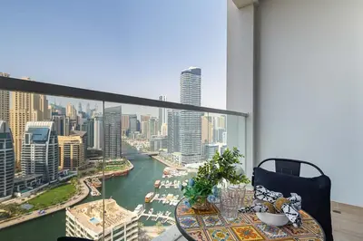 a balcony with a table and a view of a city at Frank Porter - Studio One in Dubai